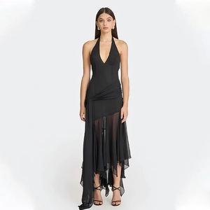 Detail of sheer mesh patchwork and asymmetrical hem on black halter deep V maxi dress
