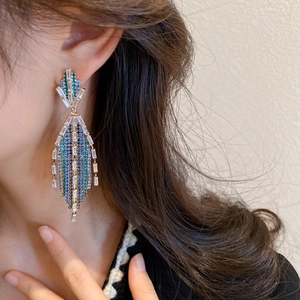 Emerald green leaf tassel earrings with sparkling crystals in a chandelier style design