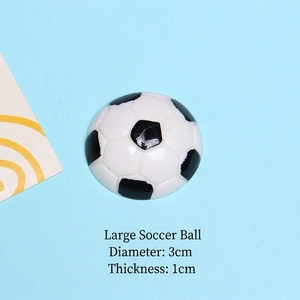 Detail view of large 3cm football resin flatback charm showing black and white patterns