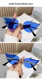 Detail of gold frame flame sunglasses with blue lenses and rhinestone embellishments
