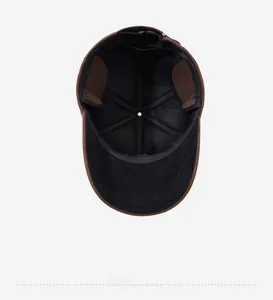 Interior view of brown winter baseball cap showing black lining and reinforced seams
