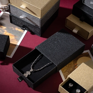 Detail of drawer-style jewelry boxes with glitter texture and ribbon pulls