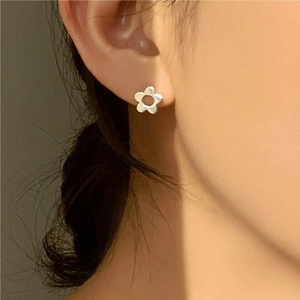 Elegant 925 sterling silver flower stud earrings for women shown worn on the ear