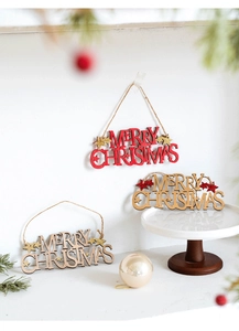 Detail of wooden Merry Christmas hanging signs with festive red and glitter finish