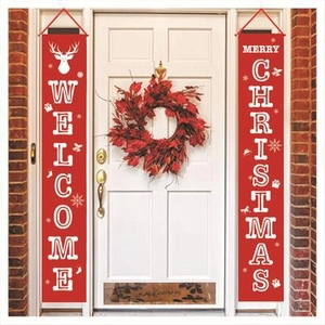 Red Christmas banners with Welcome and Merry Christmas text on white doors with brick background