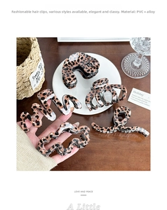 Detail view of five assorted leopard print hair claws made of PVC and alloy
