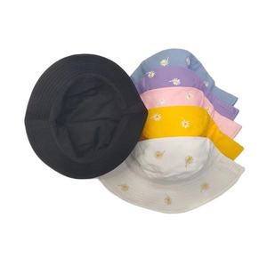 Macro shot showing diverse colors of daisy embroidery bucket hats with detailed stitching