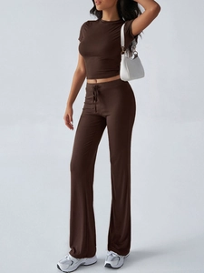 Detailed view of women's brown casual suit with short sleeve top and drawstring flared pants