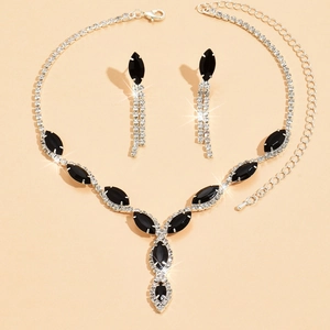 Close-up of bridal jewelry set with black marquise stones and silver tassels