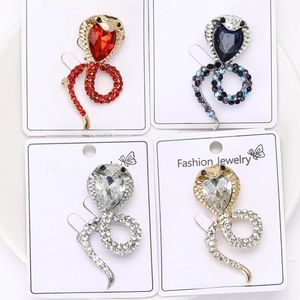 Detailed set of four rhinestone cobra snake brooches in assorted colors on display cards