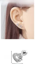 Detailed view of heart-shaped zircon earrings with bow accent and size 0.62cm x 0.73cm