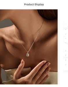 Close-up of emerald cut moissanite pendant on a delicate silver necklace worn by model