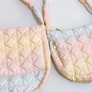 Detail of pink gradient quilted puffy shoulder bag showing texture and macaron colors