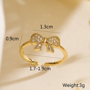 Macro detail of gold bow ring with sparkling zircons and dimensions of 1.3cm by 0.9cm