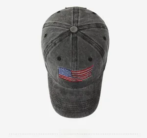 Detail of washed dark grey baseball cap with USA flag embroidery and vintage denim texture