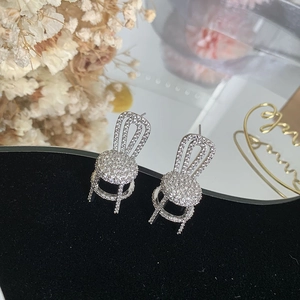 Sparkling silver chair-shaped stud earrings with micro-pave cubic zirconia on black velvet