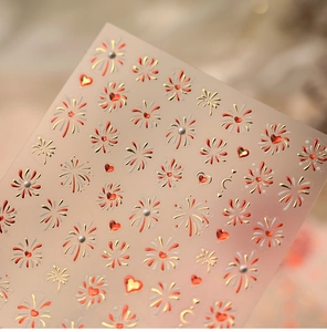 Detailed relief texture of red hearts and golden fireworks on 3D nail art stickers