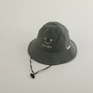 Detail of army green quick-dry sun hat with Lucky smile embroidery and windproof cord