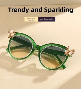 Detail of dark green sunglasses frame with micro-set rhinestones and pearl floral accents