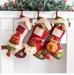 Three large Christmas stockings featuring Santa, Snowman and Reindeer hanging on a fireplace