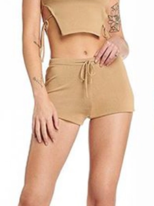 Detail of ribbed knit two-piece set featuring a camel crop top and lace-up shorts