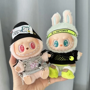 Close-up of pink and green Labubu dolls wearing miniature knitted hats and stylish outfits