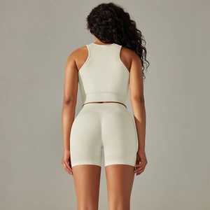 Rear view of cream seamless knitted yoga set showing racerback sports bra and high-waist shorts