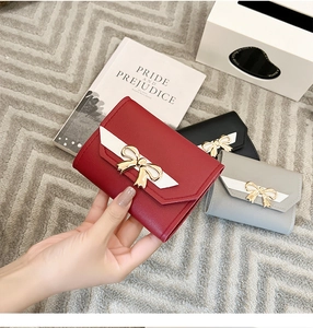 Trois portefeuilles courts pour femmes avec nœuds et détails en cuir grainé litchi