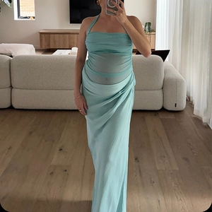 Detail view of light blue satin backless maxi dress with elegant pleats and draped fabric