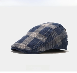 Detail showing the blue and grey plaid pattern and textured fabric of the beret hat