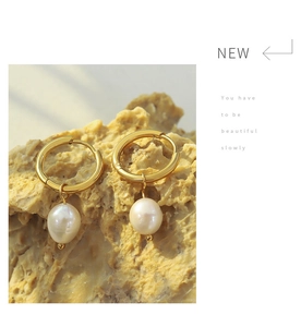 Detailed shot of 18K gold plated hoop earrings with freshwater pearls on stone