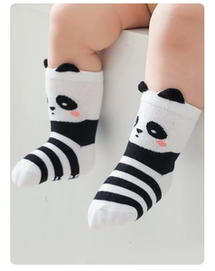 Detailed view of baby panda socks with 3D ears on a model infant for soft comfort
