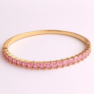 Detail view of gold-plated bracelet with square-cut pink zircon stones in a claw setting