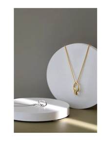 Close-up of minimalist S925 sterling silver necklaces with dual interlocking ring pendants