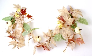 Detail of autumn garland with white pumpkins, maple leaves and yellow berries on white back