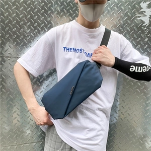 Men's navy blue geometric chest bag shown with adjustable strap and waterproof fabric