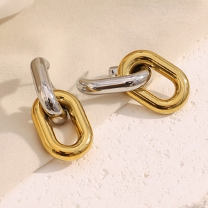 Macro shot of interlocking two-tone hollow chain earrings in 18K gold and silver steel