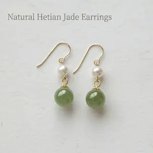 Elegant gold drop earrings featuring natural green nephrite jade and freshwater pearls