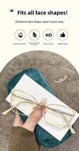 Close-up of gold metal frame glasses with transparent lenses on green suede pouch
