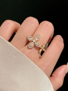 Detailed view of elegant gold flower ring with marquise-cut cubic zirconia on a model hand