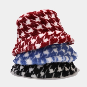 Three plush houndstooth bucket hats in red, blue, and black faux fur for winter warmth