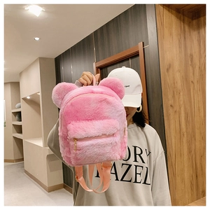 Detail of pink plush backpack featuring cute bear ears and a functional front zipper pocket