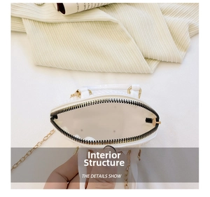 Macro view of white mini shell bag featuring quilted texture and golden chain strap