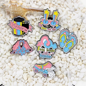 Summer enamel pins set featuring 3D glasses, roller skates and flip flops on white stones