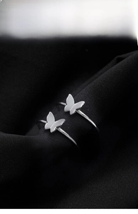 Dettaglio macro di anelli a farfalla placcati argento 925 con design a fascia aperta