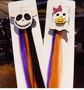 Detail of Halloween hair clips with ghost, pumpkin, and purple orange black hair extensions
