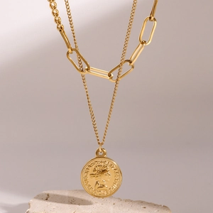 Layered gold stainless steel necklace featuring a Queen Elizabeth coin pendant on a stone