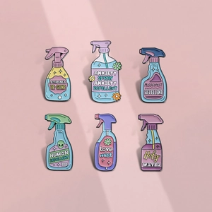 Set of 6 colorful spray bottle enamel pins with funny slogans on pink background