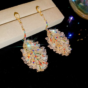 Macro detail of leaf-shaped crystal tassel earrings with colorful zircon stones