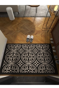 Detail of polypropylene rug with geometric ring pattern on herringbone wood floor